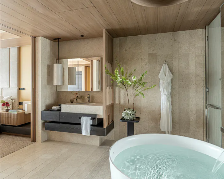 A luxurious hotel room with a standalone circular bath in the Four Seasons Osaka.
