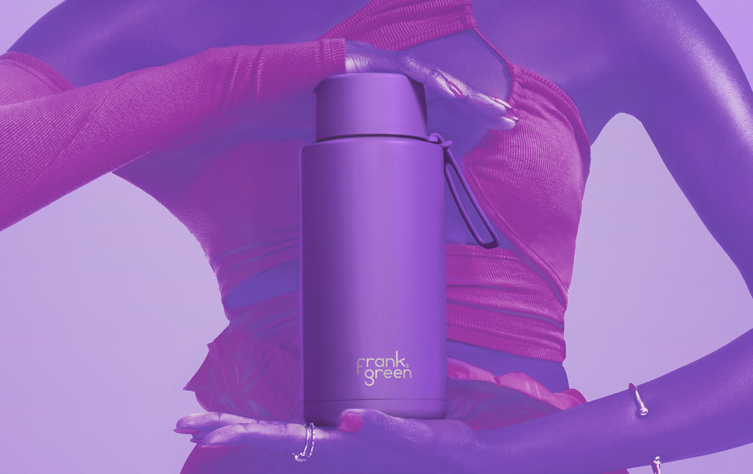 A person holding a purple drink bottle. 