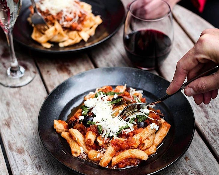 A table set with delicious Italian dishes and wine.