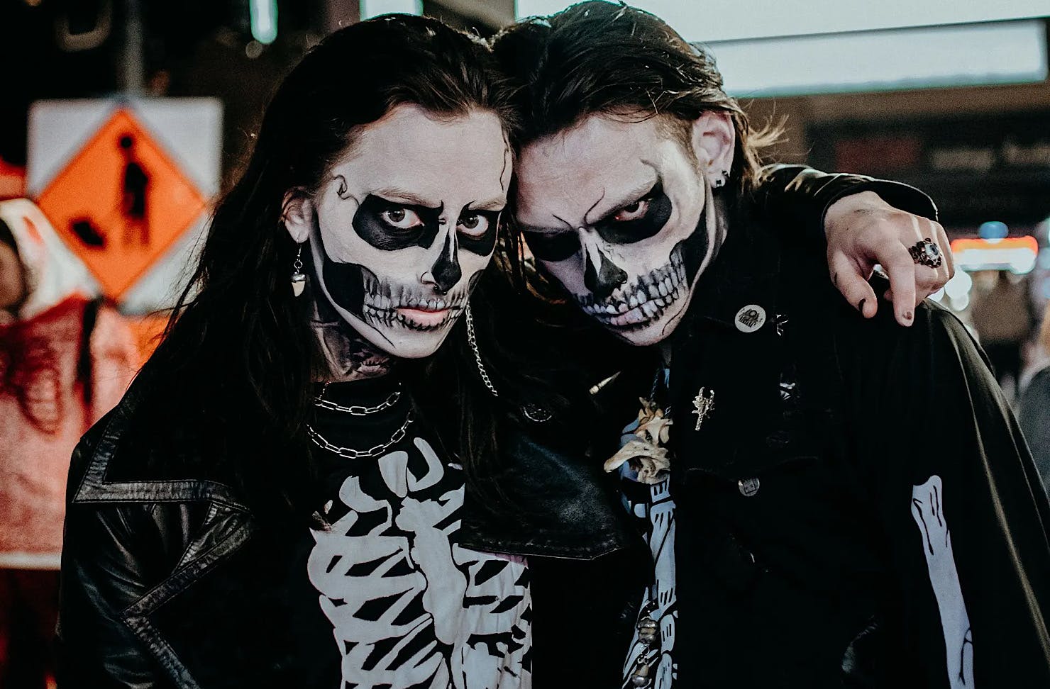 Two skeletons with ghoulish expressions. 
