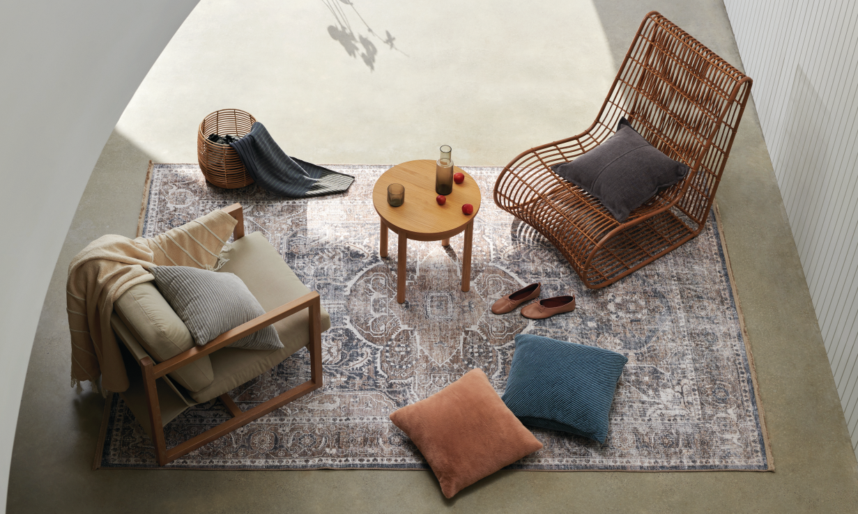 A plush seating area is adorned with velvet pillows and glass serveware.