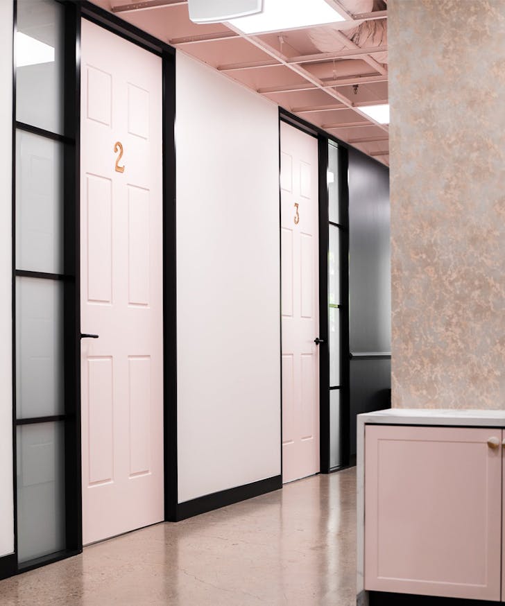 a hall of pink doors