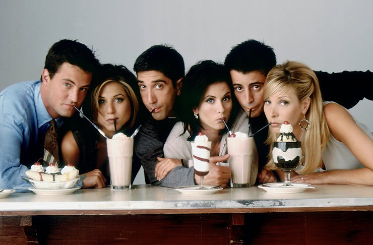 The cast of Friends drinking milk shakes and eating ice cream sundaes