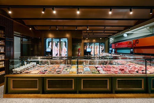 A large butcher with concrete floors.