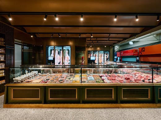 A large butcher with concrete floors. 
