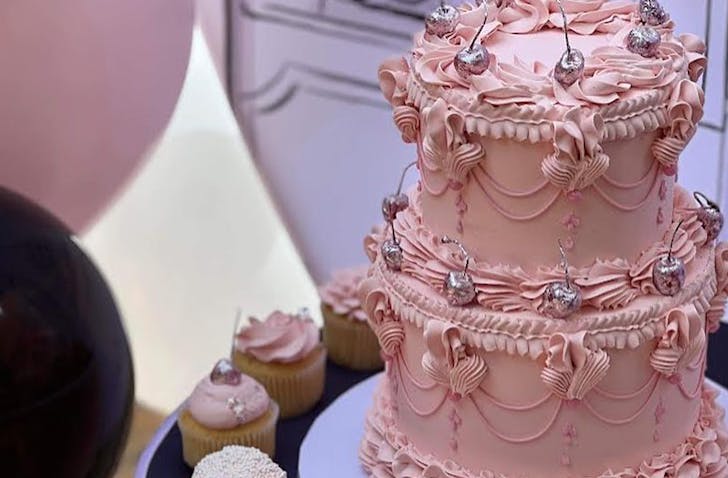 a pink and silver piped cake