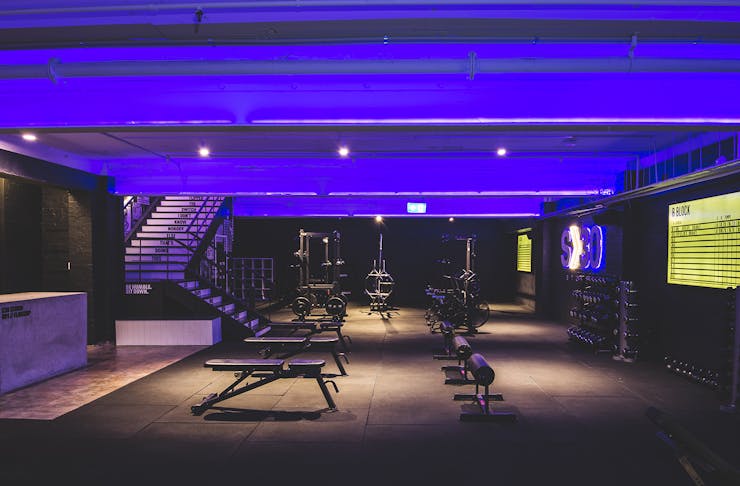 the interior of a dark, black and purple gym room