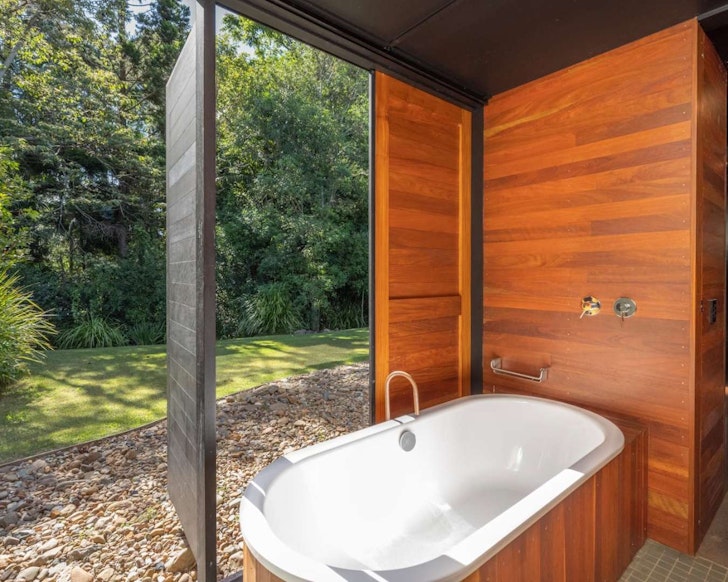 A view of the outdoor bath in the Japanese-inspired bathhouse at Grand Designs Home Airbnb near Brisband Queensland