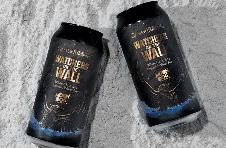 Two beer cans with Game of Thrones branding lying on a bed of snow 
