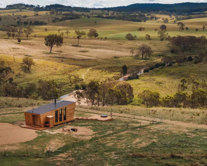 A view of the tiny home surrounded by rolling hills in Tenterfield, NSW