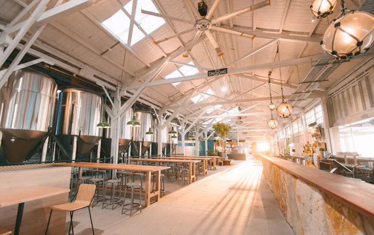 Inside the massive new Gage Roads Freo brewery with sun streaming in across the bar and dining area