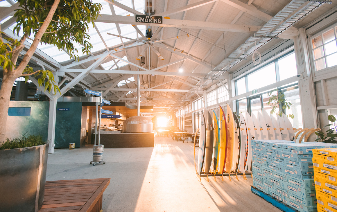 a huge light filled brewery with dining tables