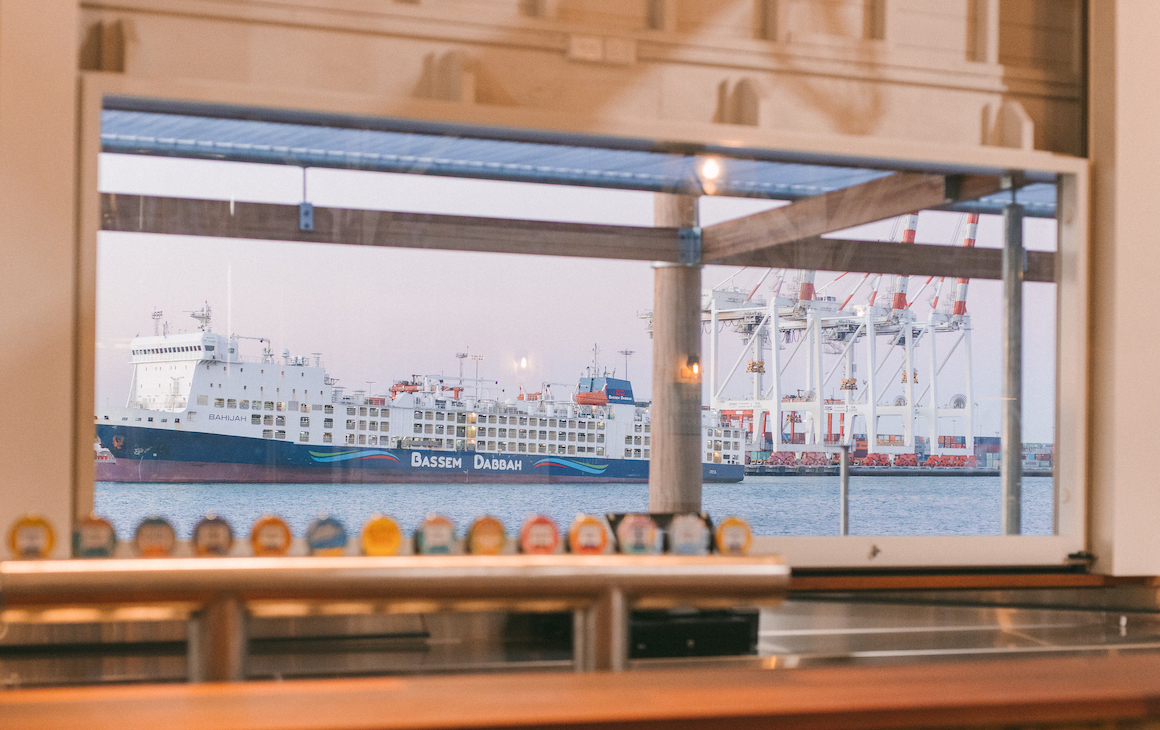 a bar looking out to the port with a container ship