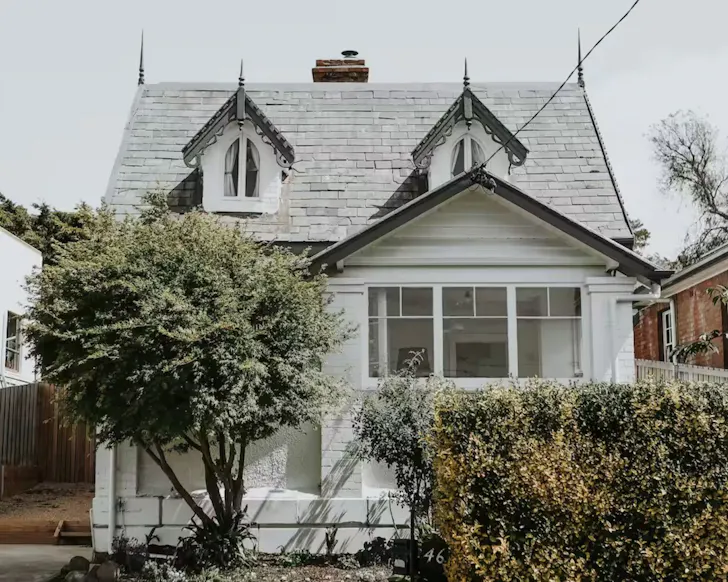The historic white exterior of The Gatekeepers Lodge one of the best Airbnbs in Hobart