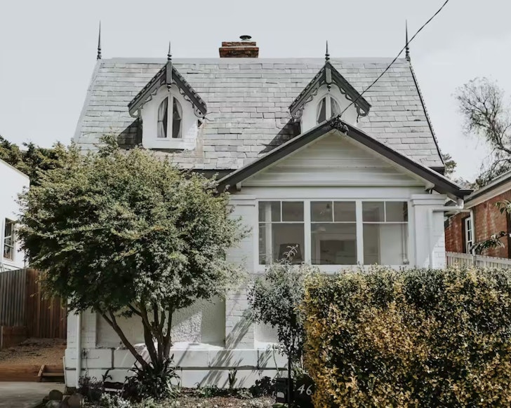The historic white exterior of The Gatekeepers Lodge one of the best Airbnbs in Hobart