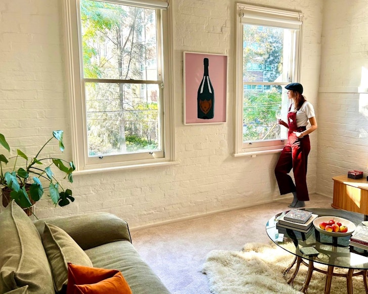A woman in the living space at Gerty Longroom one of the best Melbourne Airbnbs