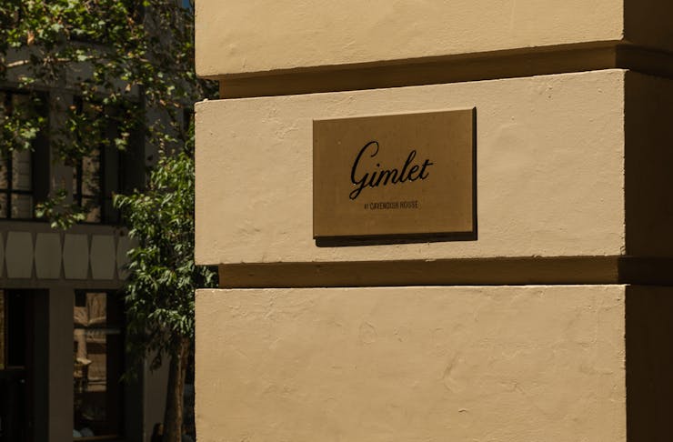 The outside of a building with a sign that reads 'Gimlet' 
