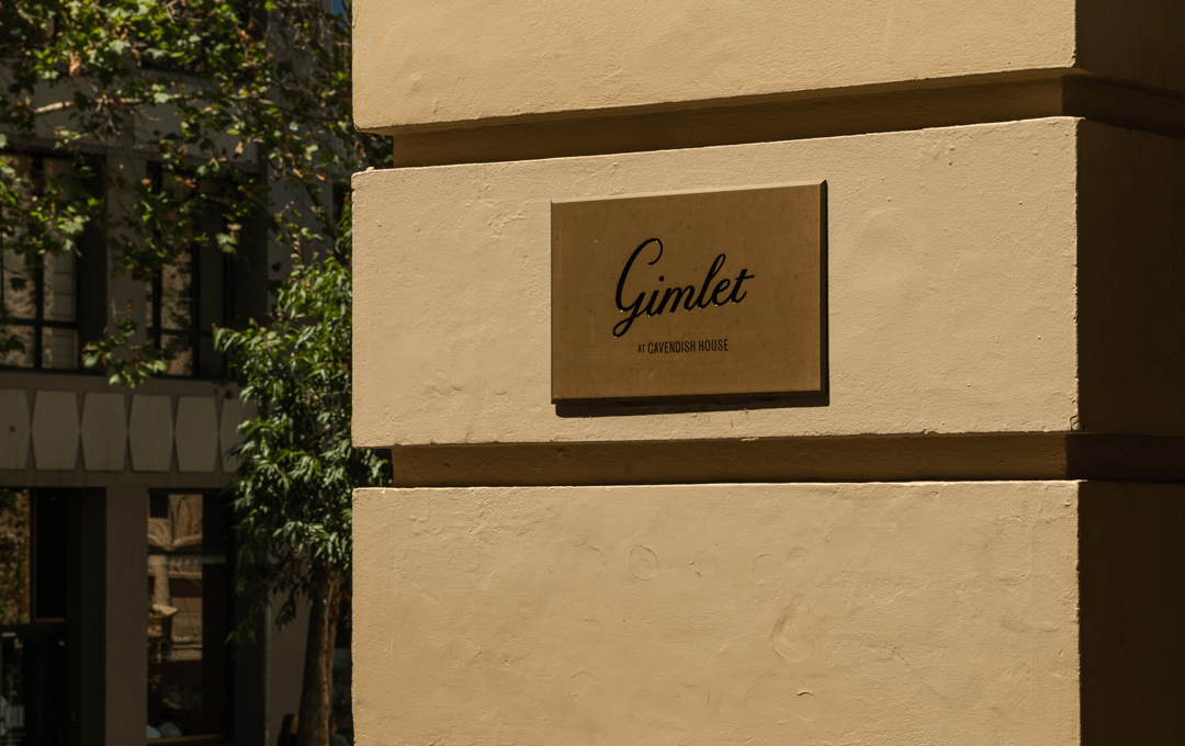 The outside of a building with a sign that reads 'Gimlet' 