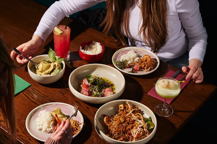 plates of food and two people reaching to eat