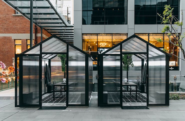 Two glasshouse dining pods outside the Heritage at Brookfield Place
