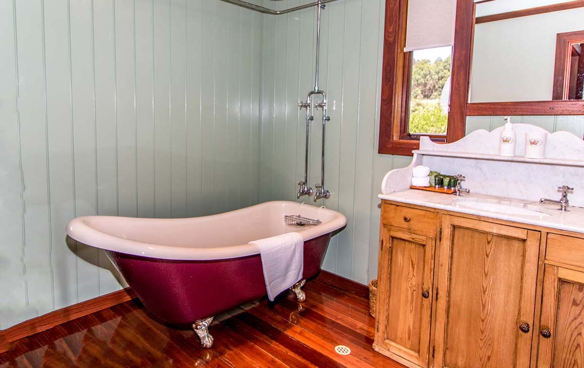 a vintage red bathtub at Glauders Cottage
