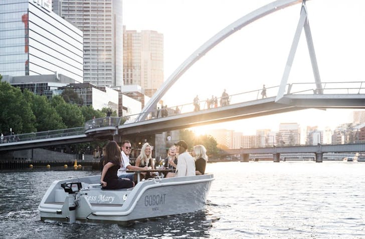  A boat on the Yarra with the CBD background, one of the best things to do in Melbourne.