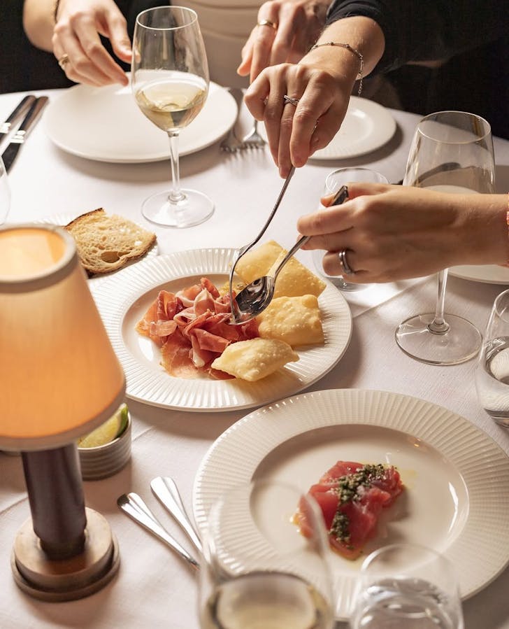 Guests serving antipasto and wine at Gran Torino, Double Bay