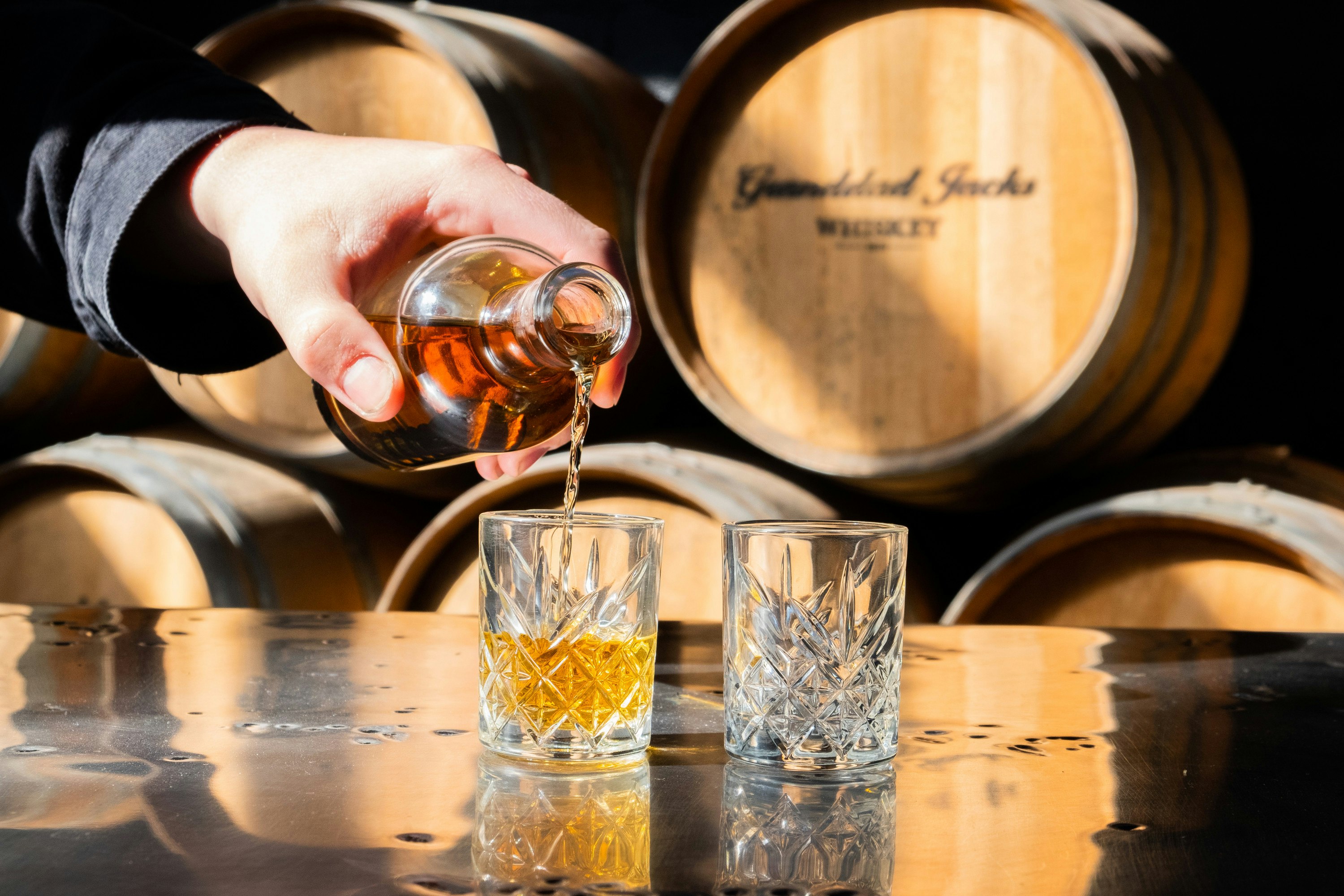 someone pouring liquor in a glass