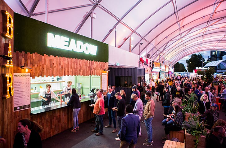  A busy food market with people eating, one of the best things to do in Melbourne.