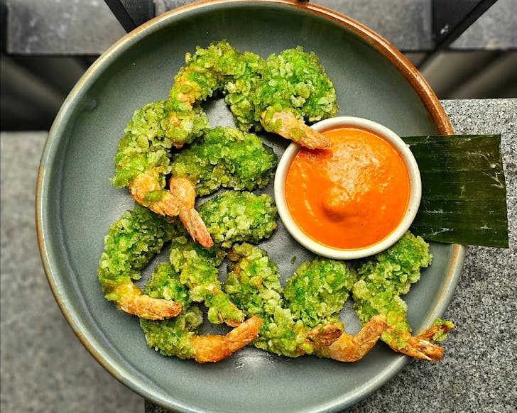 Green rice-covered Tiger prawns with orange dipping sauce at Cafe Hanoi, one of Auckland's best restaurants. 