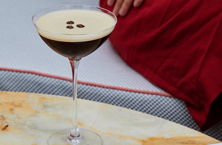 An espresso martini on a marble table.