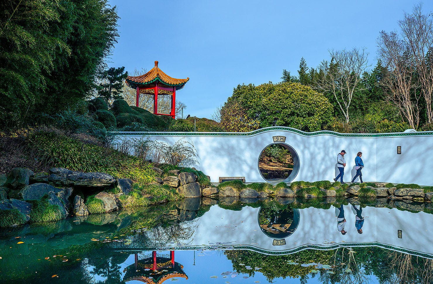 Two people wander about at Hamilton Gardens.