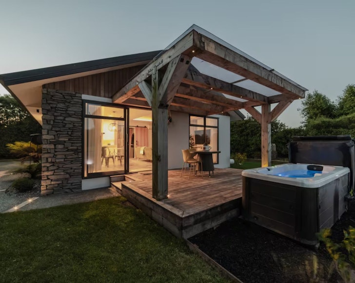 A view of the hot tub and patio at Hamptons Retreat one of the best accommodation options in Christchurch