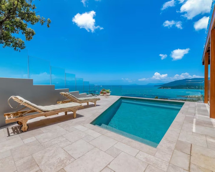 A view of the pool with a sea view at Hamptons on the Hill one of the best Airlie Beach Airbnbs