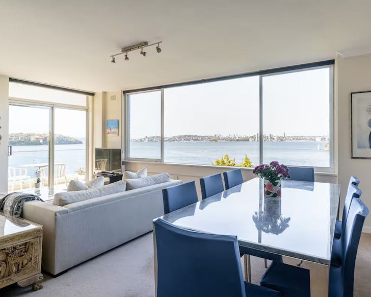 A view of the living space overlooking the harbour at this short term rental with a pool in Mosman Sydney