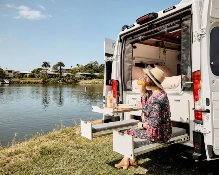 A camper at the dinner table at Harmony best family campervan hire Queensland