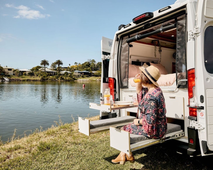 A camper at the dinner table at Harmony best family campervan hire Queensland