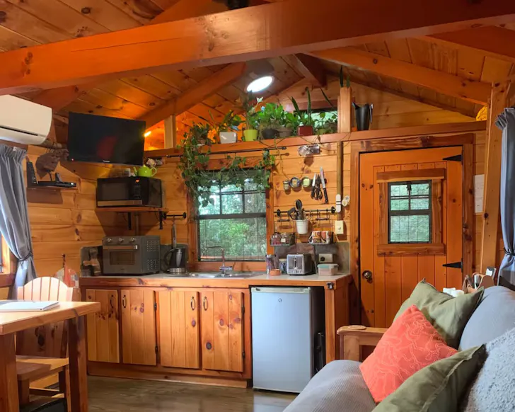 A view of the rustic kitchen and living space at Haven Retreat one of the best romantic Queensland getaways