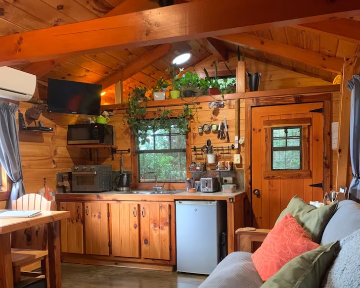 A view of the rustic kitchen and living space at Haven Retreat one of the best romantic Queensland getaways
