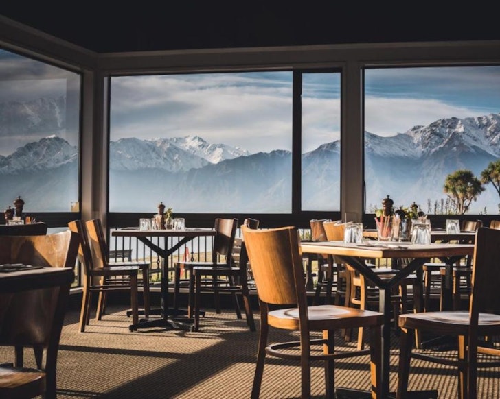 A view of the mountains through the dining room window at Hāwea Hotel one of the best accommodation options in Wanaka New Zealand