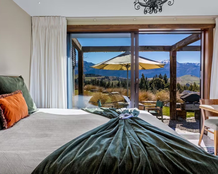 A view of the mountains from the bedroom at HawkRidge Alpine Honeymoon Suite one of the best romantic stays in New Zealand