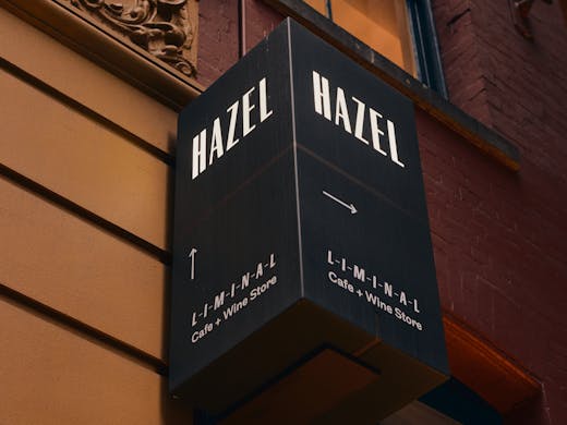 A large black sign that reads 'Hazel'