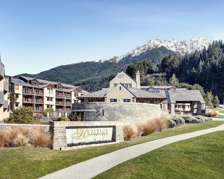 The heritage hotel with snow capped mountains behind.