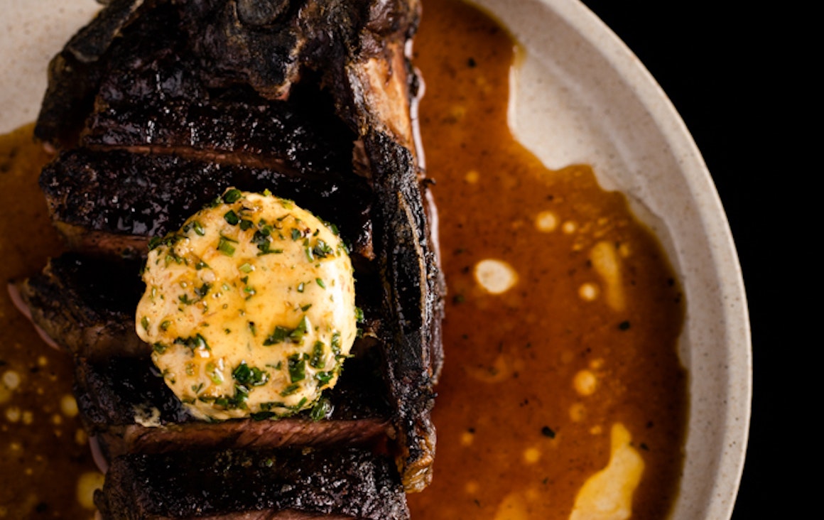 Close up image of organic grass fed beef with smoked garlic butter at Heritage Wine Bar