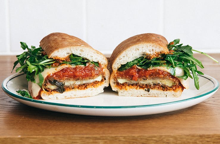 A sandwich filled with rocket, Napoli sugo, cheese, and eggplant.