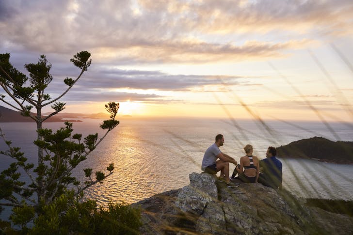 Three people on top of mountain