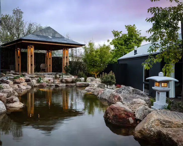 A view of the pond and pavilion at Hideyoshi Airbnb one of the best accommodation options in Daylesford