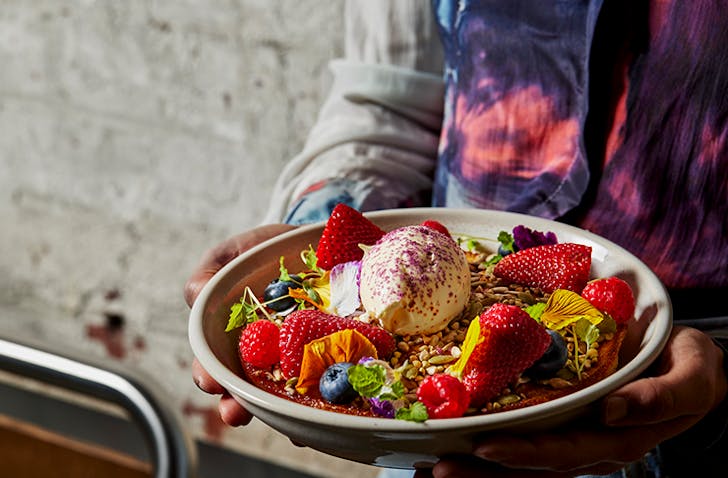 A vibrant and colourful bowl of a hotcake, topped with fresh berries and mintâone of the best breakfast Melbourne has to offer at Higher Ground