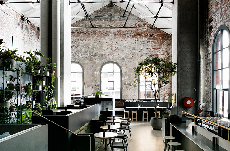 An inside of one of the best cafes in Melbourne with brick walls and arched windows.