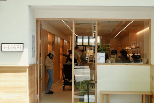 A cafe shopfront with wooden walls inside and a coffee machine up front.